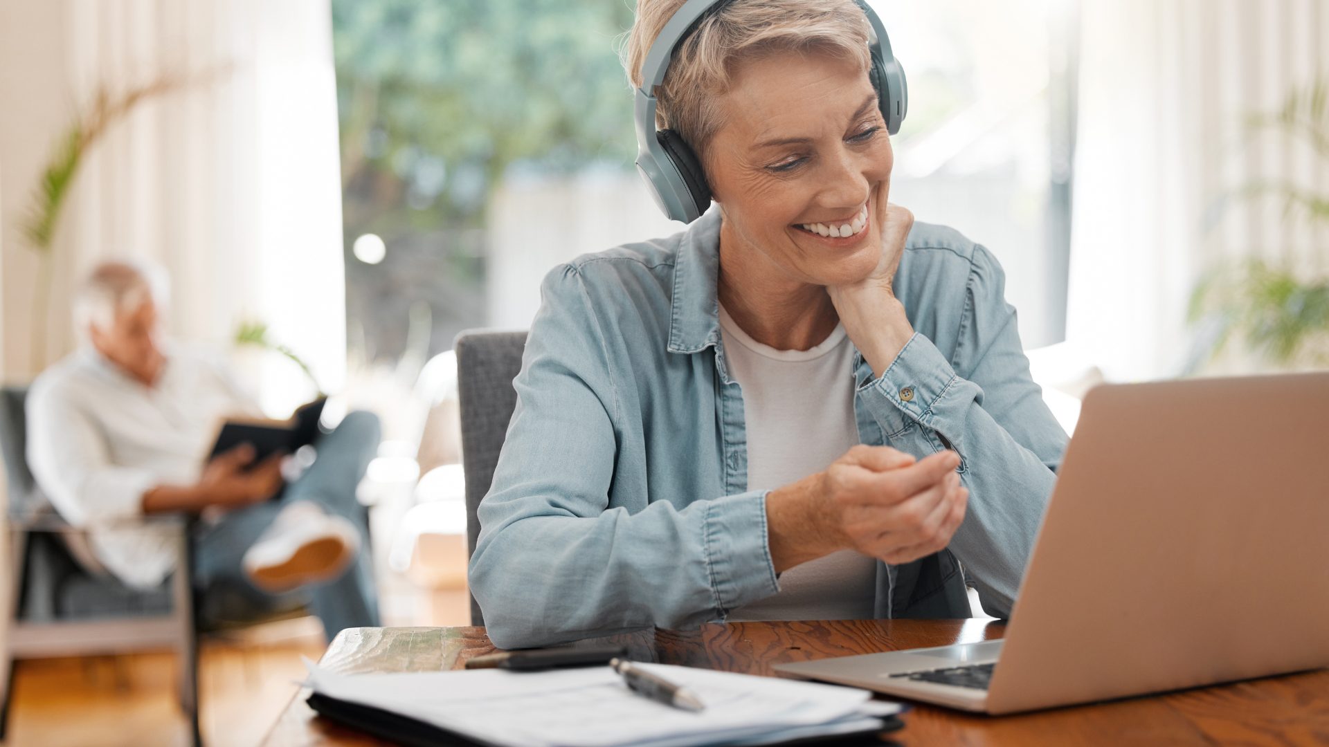 A business owner smiling on a video call at her laptop