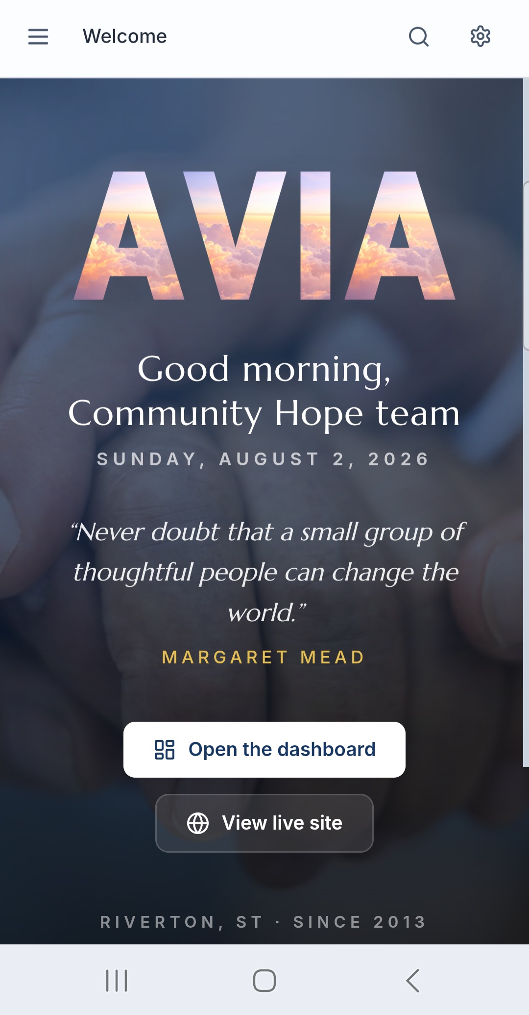 An Avia welcome screen greeting a nonprofit team by name with the date, a quote of the day, and buttons to open the dashboard or view the live public site